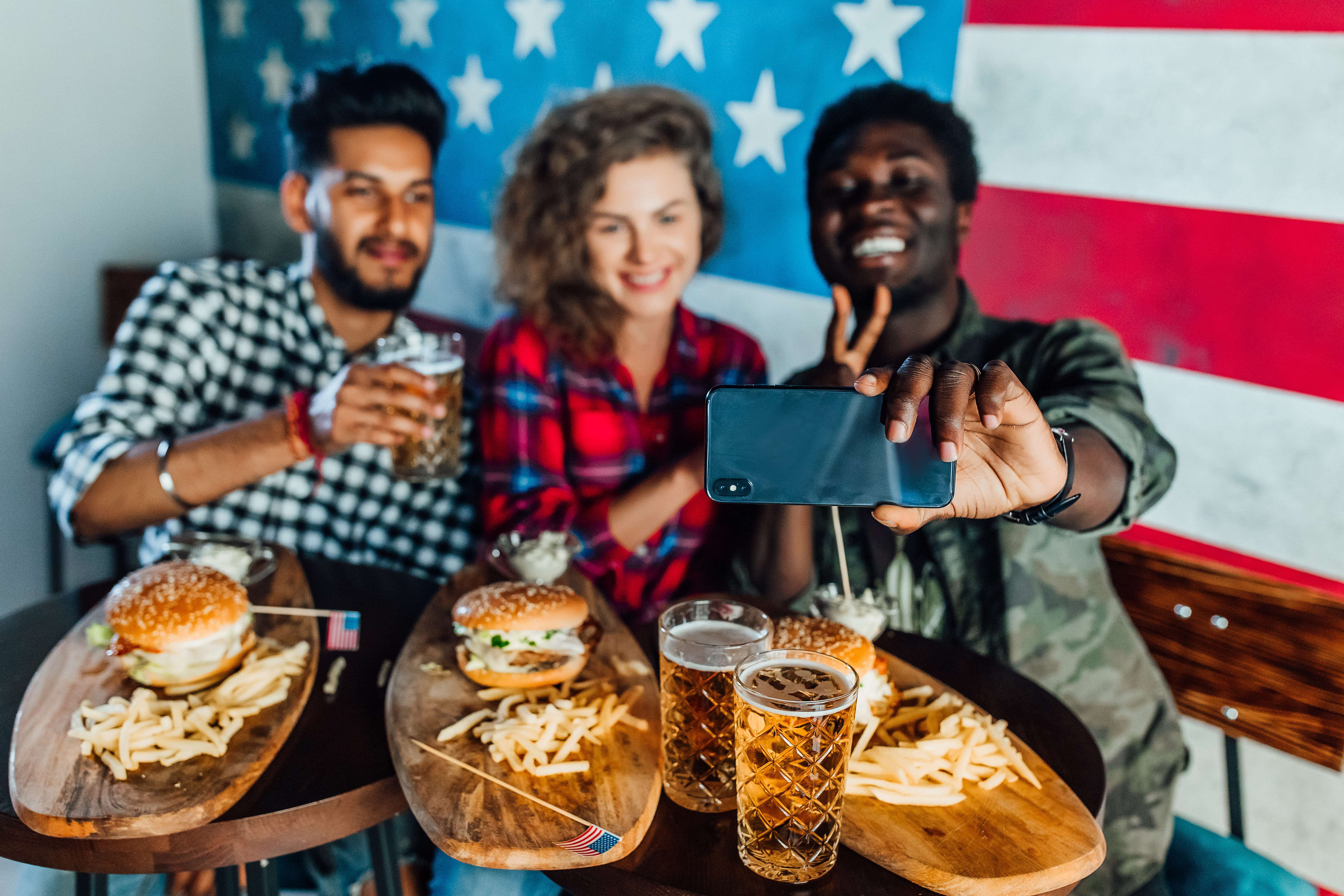 202304131208.jpg happy-three-friends-fast-food-restaurant-taking-selfie-while-they-are-eating-burgers-drinking-beer (1).jpg